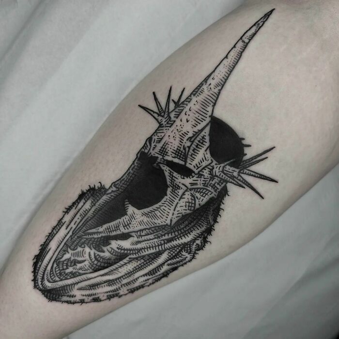 Lord of the Rings tattoo featuring a detailed dark helmet with spikes on a forearm.