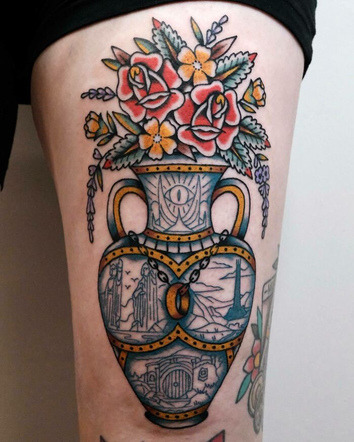 Lord of the Rings tattoo featuring a vase with flowers, Eye of Sauron, and the One Ring, showcasing iconic designs.