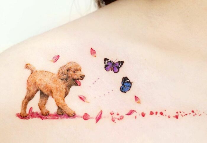 Dog Walking A Flowery Road With Butterflies collarbone Tattoo