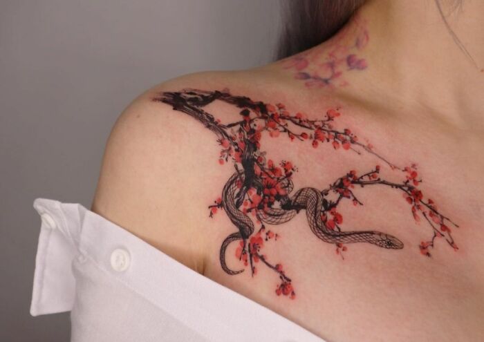 Snake On A Sakura Branch on collarbone Tattoo