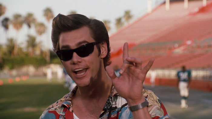 Ace Ventura in dark glasses on the stadium background