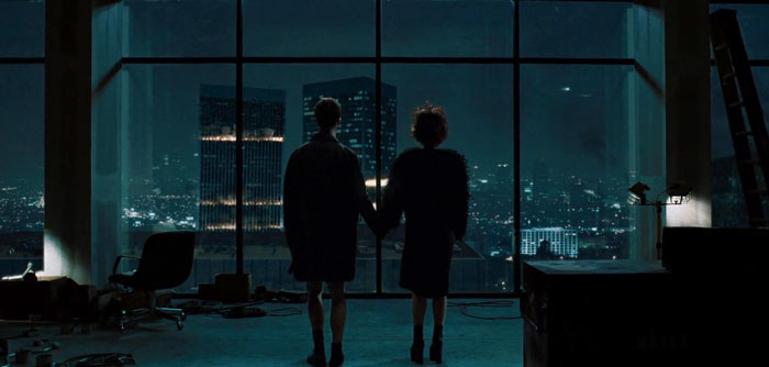 Narrator and Marla staying with holding hands near the glass windows 