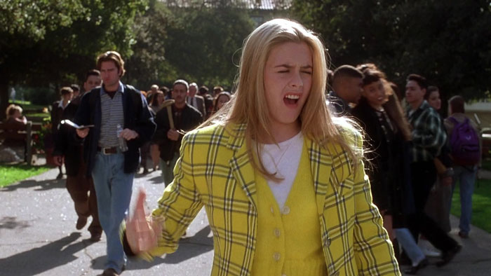 Cher Horowitz with a grimaced face in the street full of people