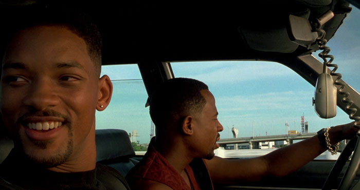 Mike Lowrey and Marcus Burnett driving in a car
