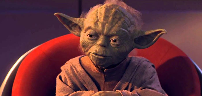 Yoda sitting in a red armchair