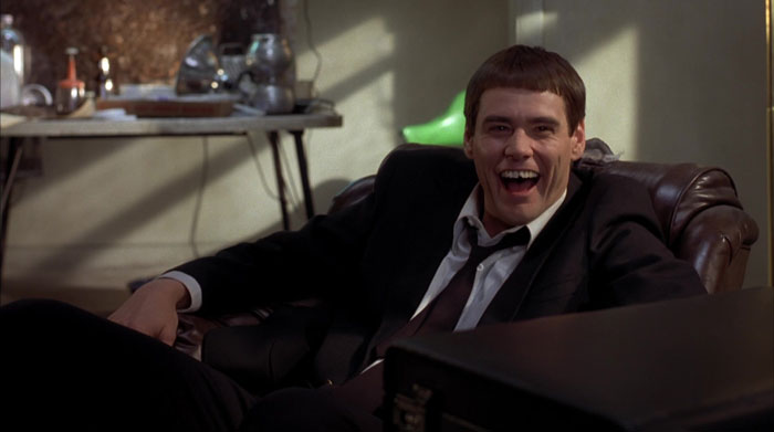 Lloyd sitting in the armchair and laughing