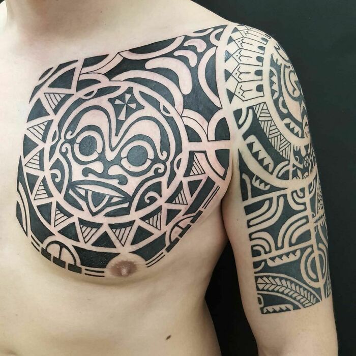 Polynesian Arm And Chest Tattoo