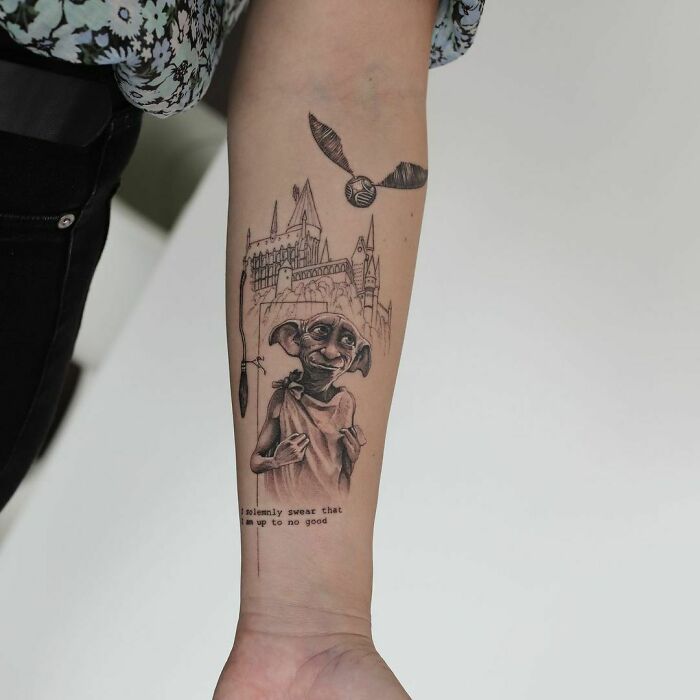 Pop culture tattoo of a house elf, castle, and flying ball on a forearm, illustrating a fantasy theme.