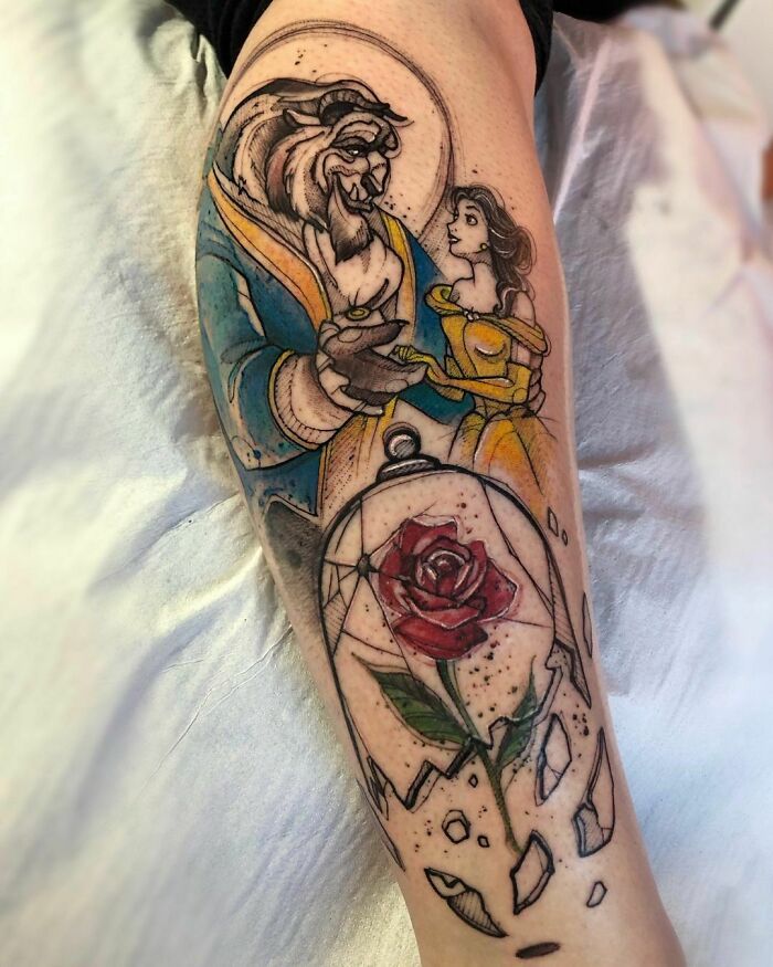 Pop culture tattoo featuring Beauty and the Beast with a shattered rose on a forearm.