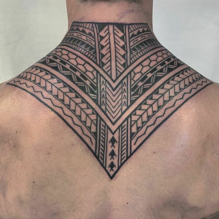 Tribal tattoo design covering the back of the neck, featuring intricate geometric patterns.