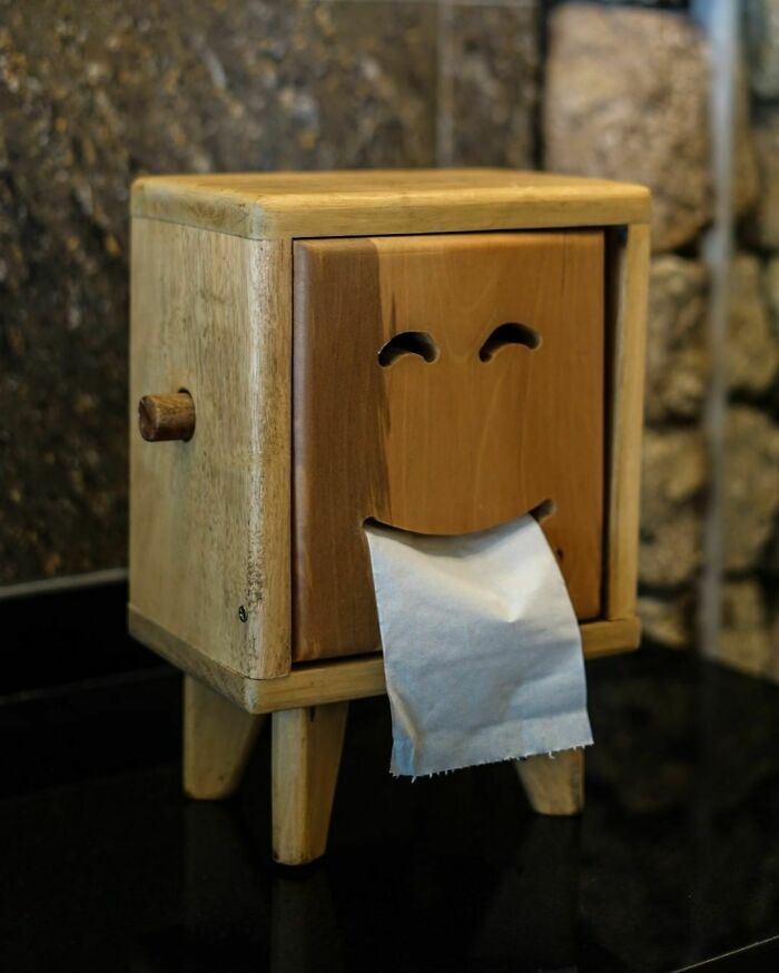Wooden toilet paper roller like a smiley face 