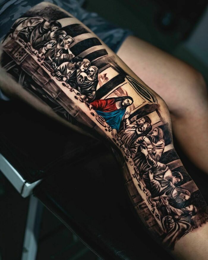 Pop culture tattoo of "The Last Supper" scene on a person's arm, showing detailed and vivid artwork.