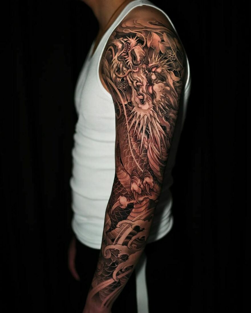 Black Ink Dragon Tattoo On Sleeve Facing Upwards