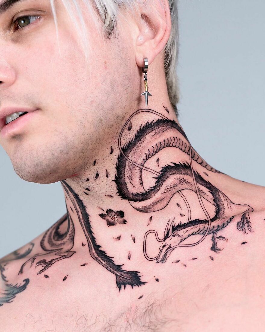 neck tattoo of a haku dragon surrounded by leaves and a flower