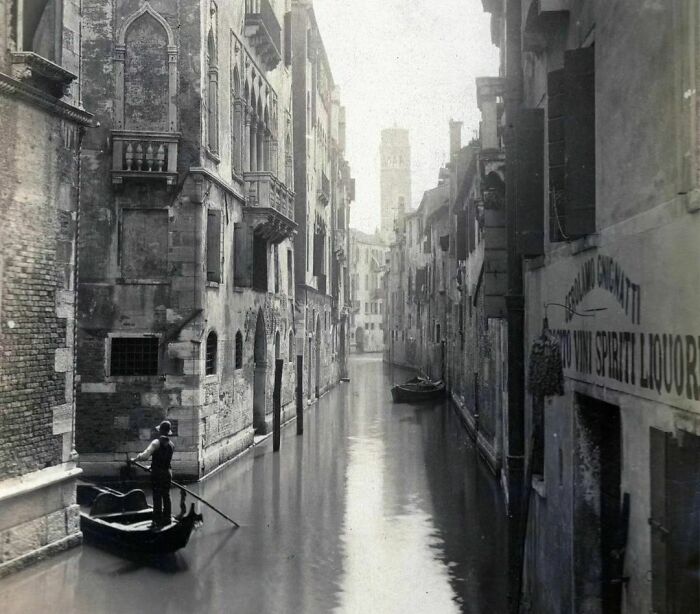 A Gondolier Passes By The Residential Homes Of The City Of Venice, Kingdom Of Italy, C. 1900