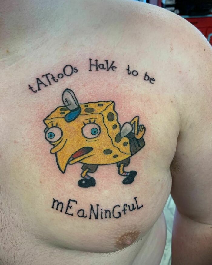 Pop culture tattoo of a quirky cartoon character on a person's chest with text "tattoos have to be meaningful."