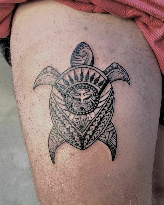 Tribal turtle tattoo with intricate patterns on a person's leg.