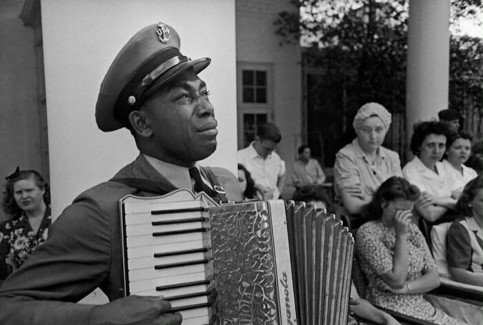 (Fdr Funeral) Tears Stream Down The Cheeks Of Accordion-Playing Chief Petty Officer Graham Jackson As President Franklin D. Roosevelt's Flag-Draped Funeral Train Left Warm Springs, Georgia, On April 13, 1945. Roosevelt's Fellow Polio Victims Sit Crying At Jackson's Side