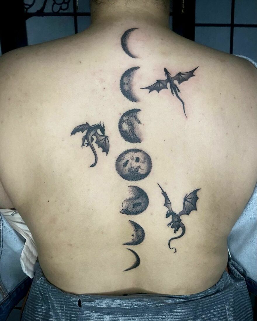 back tattoo of three dragons and different phases of the moon
