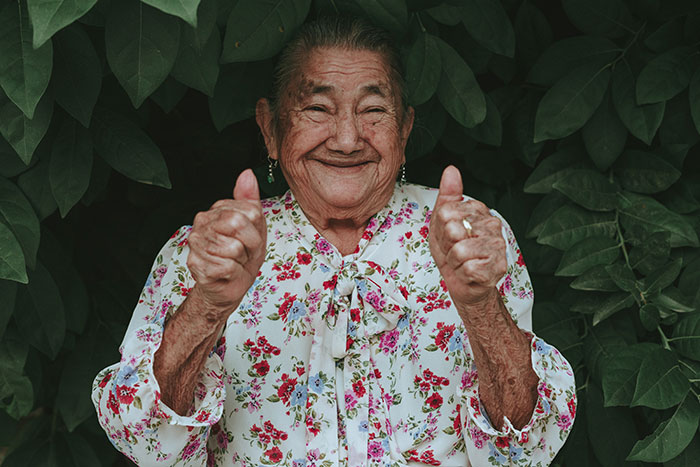 Grandma smiling and holding thumbs up