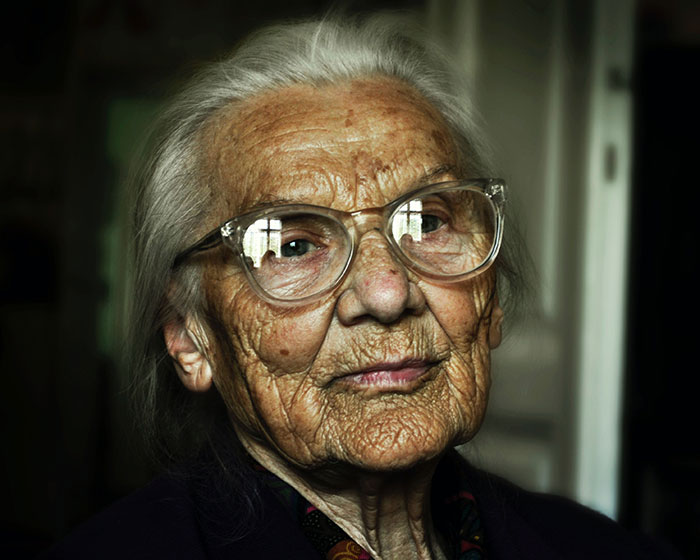 Old woman wearing glasses and looking