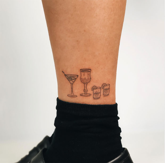 Glasses of alcohol drinks ankle tattoo