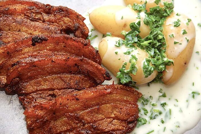 Denmark. Roasted Pork With Potatoes And A White Souce With Parsley
