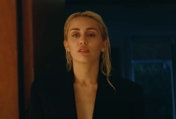 Miley Cyrus looking at someone in the dark 