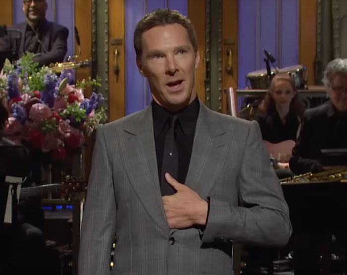 Benedict Cumberbatch talking with his hand in a jacket 