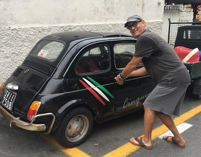 Tom Hanks opening door of a small car 