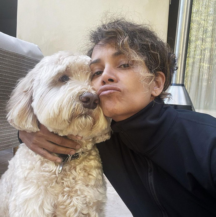 Halle Berry posing for a selfie with her white dog 