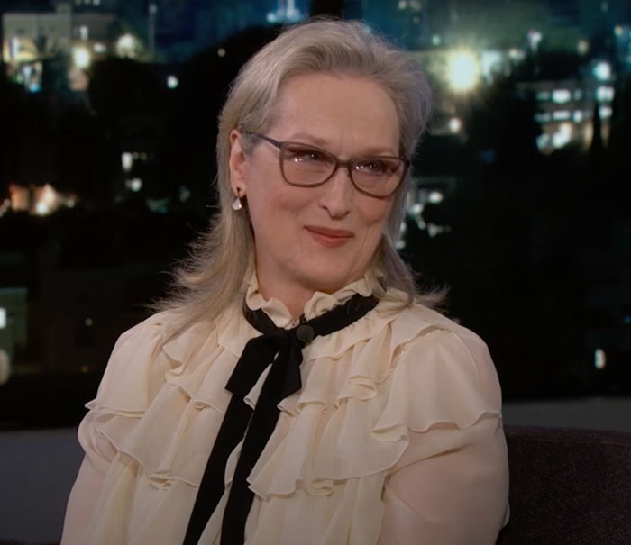 Meryl Streep sitting and looking to the side 