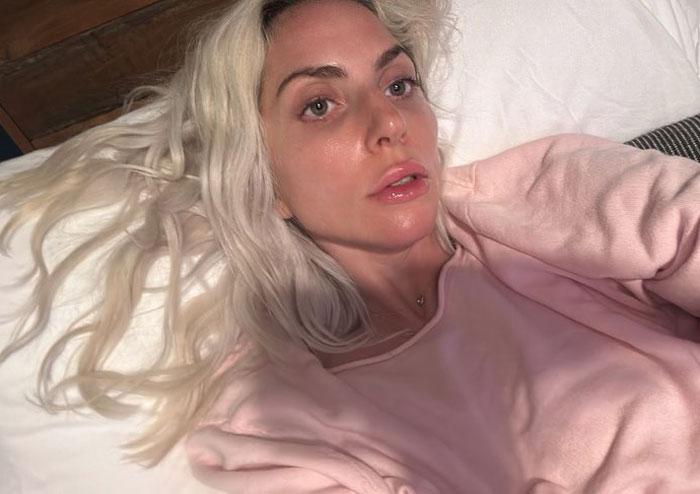 Lady Gaga laying in bed and talking a selfie 