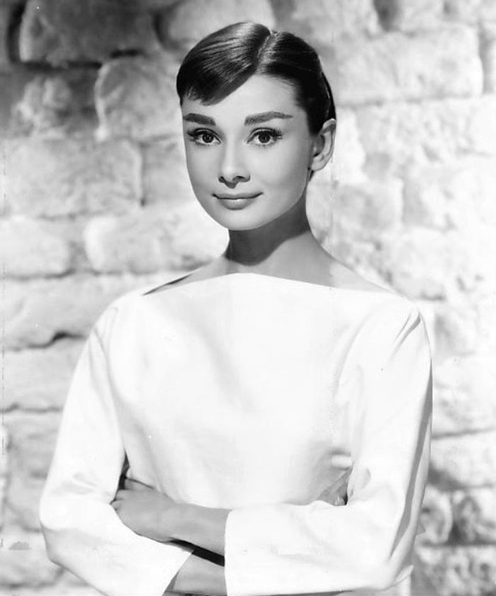 Audrey Hepburn posing with her hands crossed 