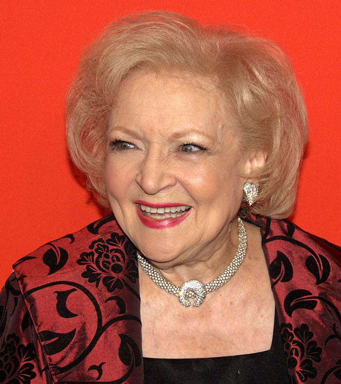 Betty White looking to the side and laughing 
