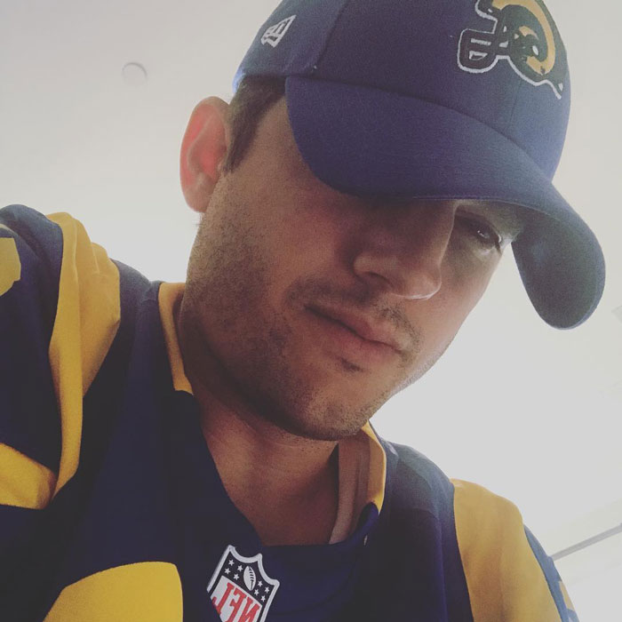 Ashton Kutcher looking down at someone 