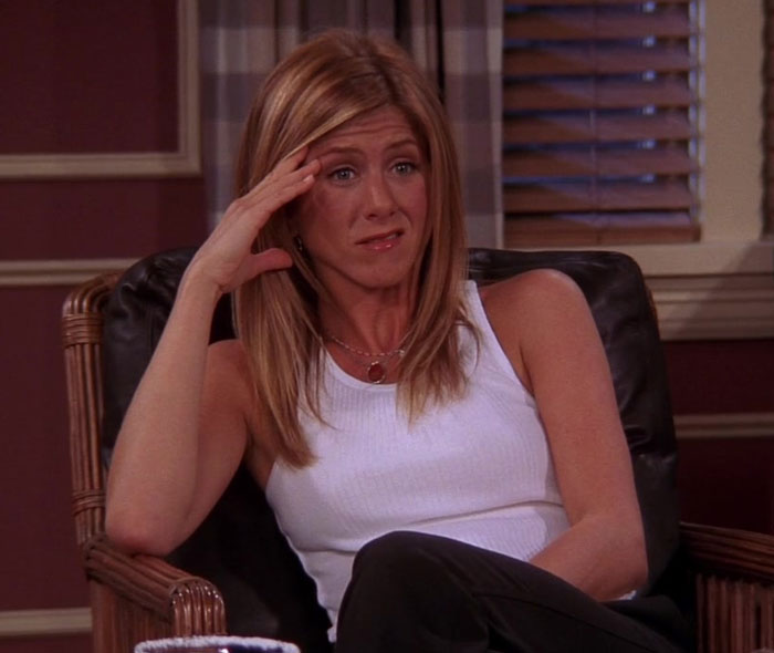 Rachel wearing white shirt and sitting on the chair 