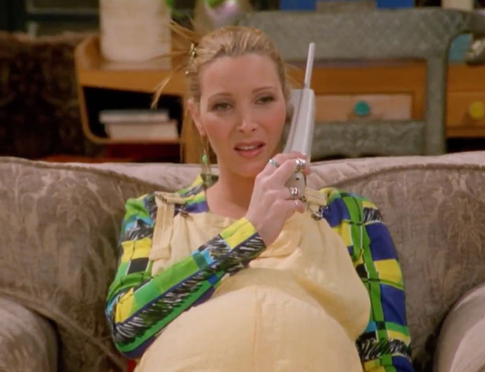 Pregnant Phoebe is on the phone 