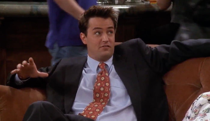 Chandler sitting on the couch in the coffee house 