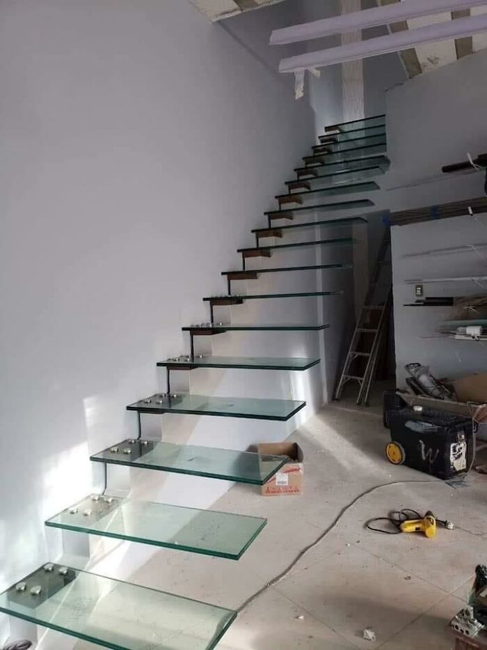 A Stair Where Each Steap Is A Slab Of Glass Rigidly Bolted To The Wall. No Handrail, No Non-Slip Insert, Just Glass