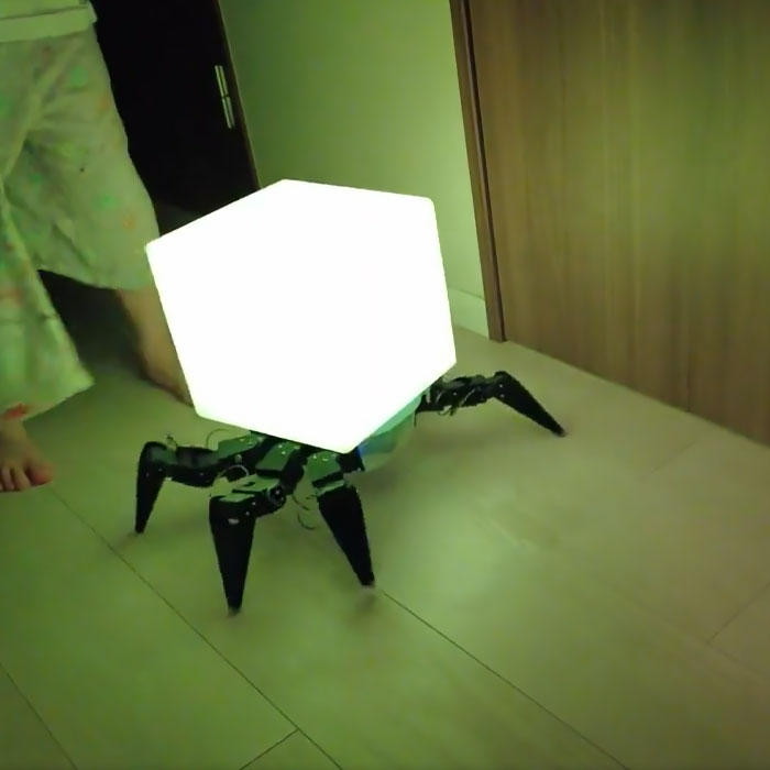 Glowing robot bedside lamp with spider-like legs