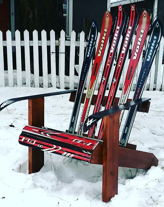 A chair made from skis outside in the snow