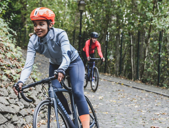 Two girls cycling in a mountain track 