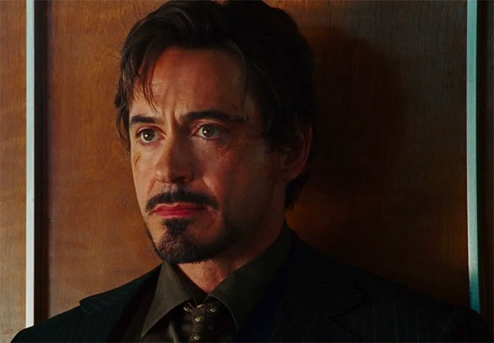 Korg Tony Stark in the classic outfit in front of a wooden wall