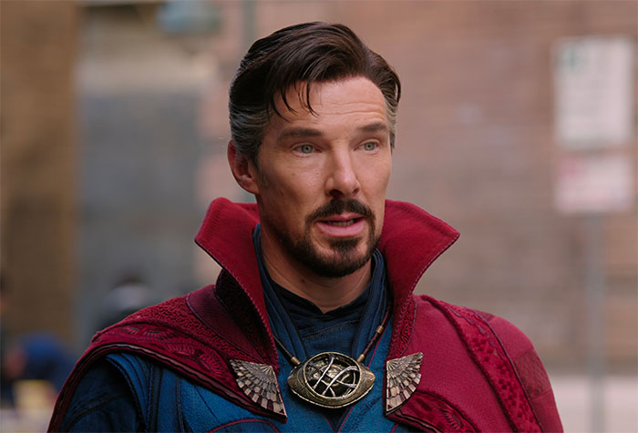 Doctor Strange in red cloak is standing and talking