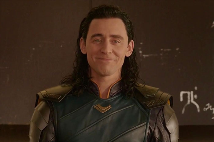 Loki is in a leather jacket and smiling