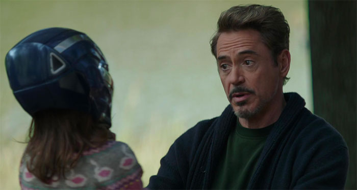 Tony Stark is talking with a girl who wears a blue helmet