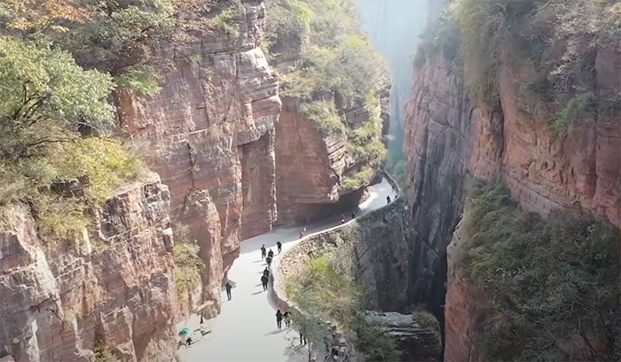 Picture of people walking on Guoliang Tunnel road in China