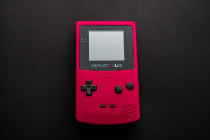 Red Game Boy Color On Black Table 