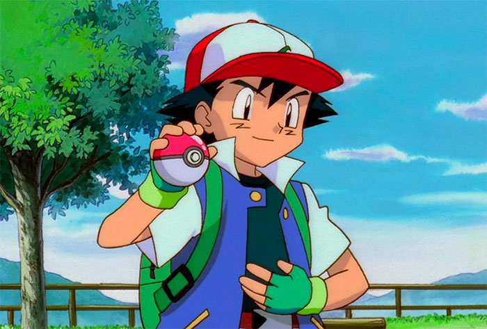 Ash Ketchum standing and holding poke ball in his right hand